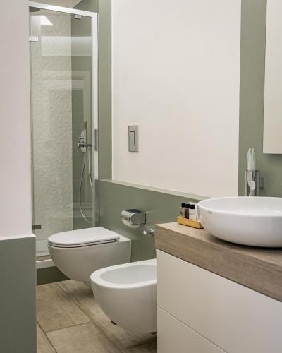 a bathroom with two sinks and a toilet at Museo19 in Naples