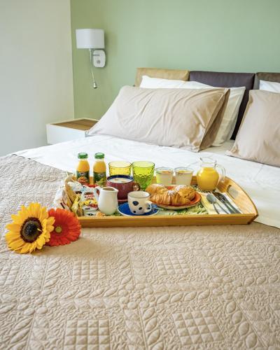 a tray of breakfast food on a bed at Museo19 in Naples