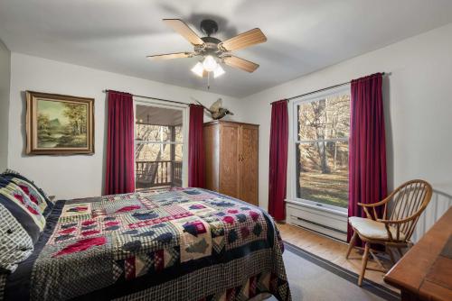 a bedroom with a bed and a ceiling fan at River Access Loft Deck WiFI & Pet Friendly in Great Cacapon