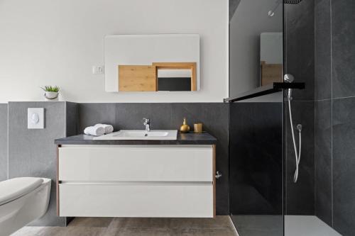 a bathroom with a white sink and a shower at Santalezi Sunset Villa - Nature and Private Pool in Santalezi