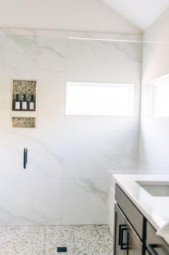 a bathroom with a shower and a sink at Little River Retreat in Townsend