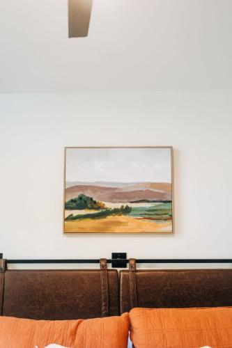 a painting hanging on a wall above a couch at Little River Retreat in Townsend