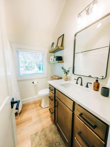 a bathroom with a sink and a mirror at Little River Retreat in Townsend