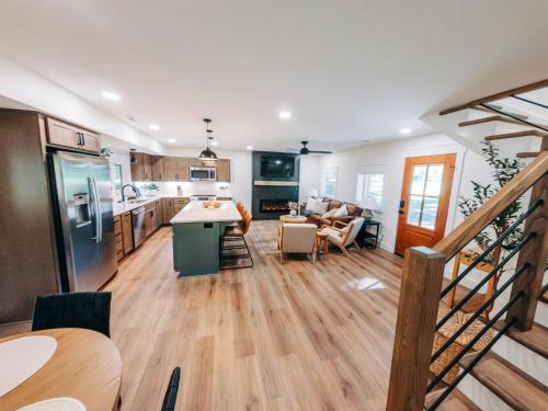 a large kitchen and living room with a staircase at Little River Retreat in Townsend