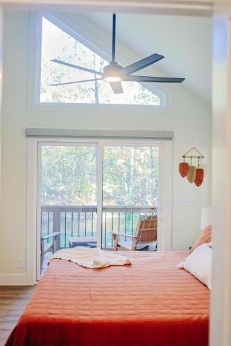 a bedroom with a large bed and a large window at Little River Retreat in Townsend