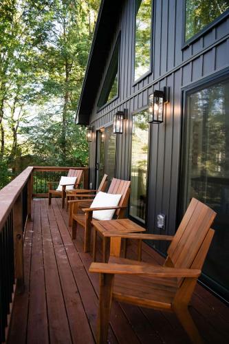 a row of wooden benches sitting on a deck at Little River Retreat in Townsend