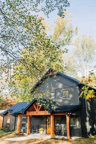 a black house with a gambrel roof at Little River Retreat in Townsend