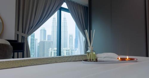 a room with a window with a view of a city at Eaton Residence KLCC - KL SUITE in Kuala Lumpur