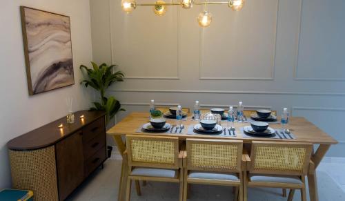a dining room with a wooden table and chairs at Eaton Residence KLCC - KL SUITE in Kuala Lumpur