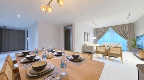 a dining room with a table and a living room at Eaton Residence KLCC - KL SUITE in Kuala Lumpur