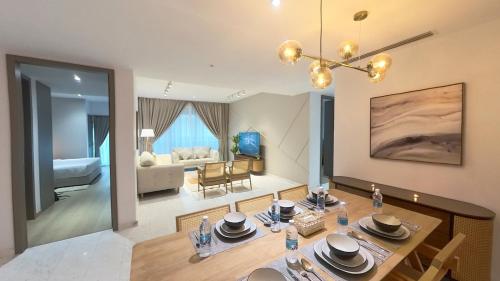 a room with a dining table and a living room at Eaton Residence KLCC - KL SUITE in Kuala Lumpur