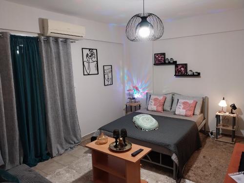 a bedroom with a bed and a table in it at Studio Byron in Mesolongion