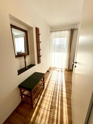 a room with a bench and a mirror on the wall at Apartments Sunnseitn by Gerrit & Herfried in Krumpendorf am Wörthersee