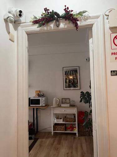 an open door into a kitchen with a table and a microwave at Pension Angelines, Sneuu Hostel Santander in Santander