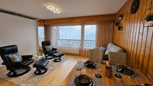 a living room with two chairs and a couch at Studio 4206 Les Sources aux Bains d'Ovronnaz in Ovronnaz