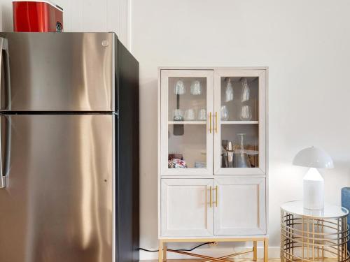 a kitchen with a refrigerator and a white cabinet at Bubbles in the Sand in Tybee Island