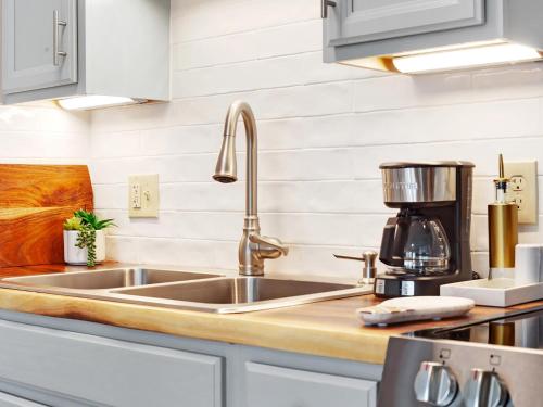 a kitchen with a sink and a coffee maker at Bubbles in the Sand in Tybee Island