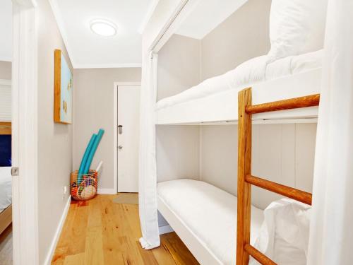 a room with bunk beds in a house at Bubbles in the Sand in Tybee Island