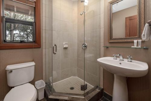 a bathroom with a shower and a toilet and a sink at Montebello by Whistler Premier in Whistler
