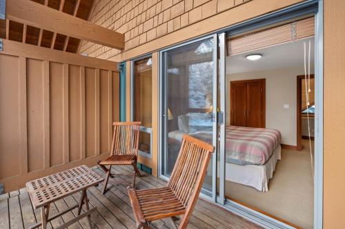 a room with a balcony with a bedroom and a bed at Montebello by Whistler Premier in Whistler