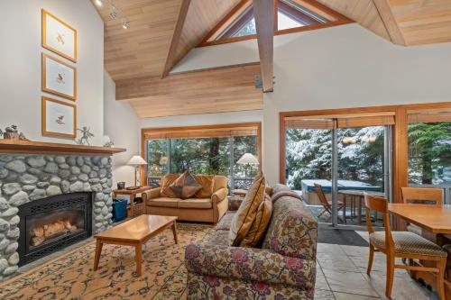 a living room filled with furniture and a fireplace at Montebello by Whistler Premier in Whistler