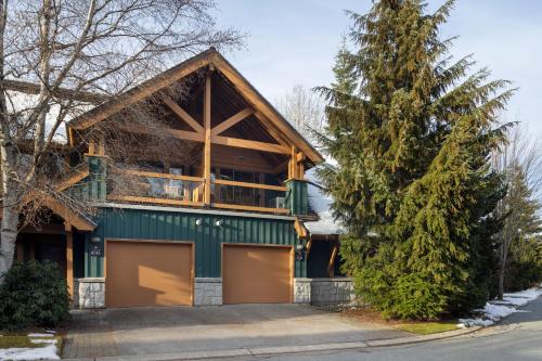 a house with a garage and a tree at Montebello by Whistler Premier in Whistler