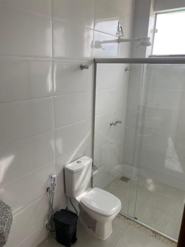 a white bathroom with a toilet and a shower at Hotel Primavera Palace in Salinas