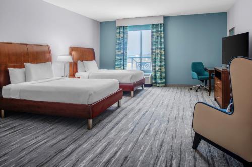 a hotel room with two beds and a desk at Hilton Garden Inn Charleston / Mt. Pleasant in Charleston