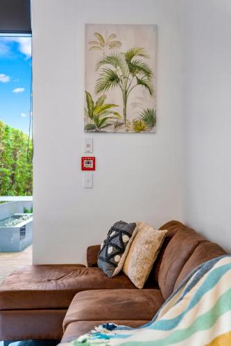 a couch in a living room with a picture on the wall at Loft Retreat in Auckland