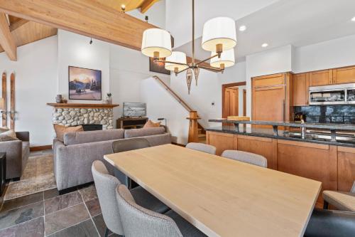 a dining room and living room with a table and chairs at Montebello by Whistler Premier in Whistler