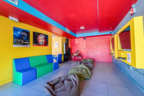a room with colorful walls and couches at Ramada by Wyndham Flamingo Water Park in Kissimmee