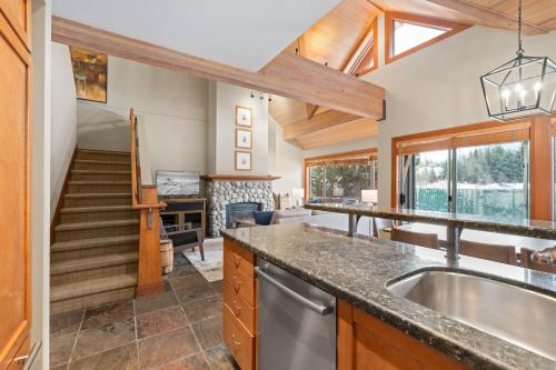 a kitchen with a sink and a staircase at Montebello by Whistler Premier in Whistler