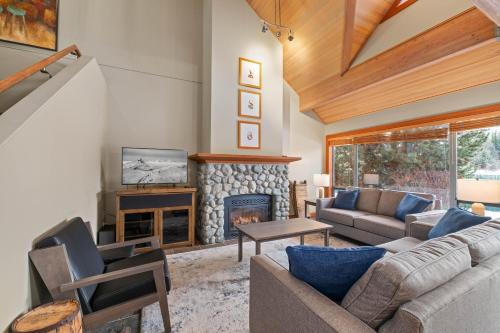 a living room with a couch and a fireplace at Montebello by Whistler Premier in Whistler