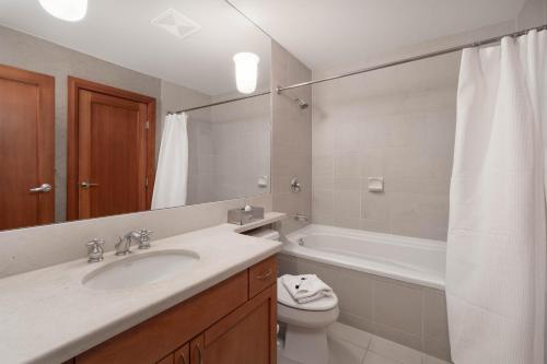 a bathroom with a sink and a toilet and a tub at Montebello by Whistler Premier in Whistler