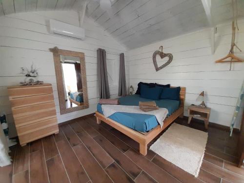 a bedroom with a bed and a mirror at Bungalow Blue Balawou in Le François