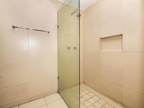 a walk in shower with a glass door at Hotel JM in Celaya