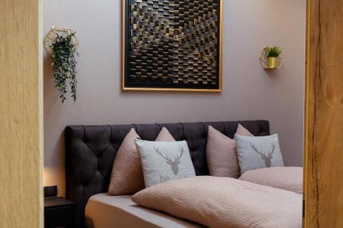 a couch with pillows on it in a room at Posthof - Alpine Living Apartments in Campo di Trens
