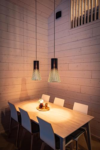 a dining room table with chairs and two lights at Vuokatti Weekend Platinum I in Vuokatti
