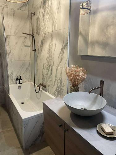 a bathroom with a sink and a bath tub and a sink at Casa Lariz in Hasselt