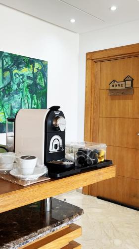 a coffee maker sitting on a counter next to a door at Seaside studio with pool in Dar Bouazza