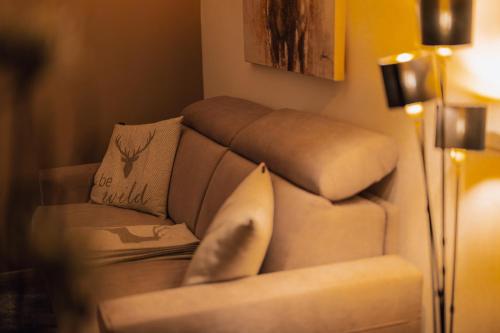 a living room with a couch and a chair at Posthof - Alpine Living Apartments in Campo di Trens