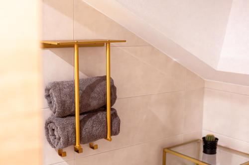 a set of three towels on a shelf in a bathroom at Posthof - Alpine Living Apartments in Campo di Trens