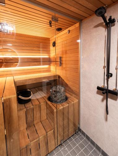 a sauna with wood paneled walls and a wooden ceiling at Vuokatti Weekend Platinum in Vuokatti