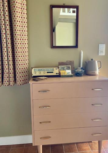 a dresser with a mirror on top of it at Fleur & Mer in Montfarville