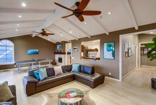 a living room with a couch and a ceiling fan at GrandView in Encinitas