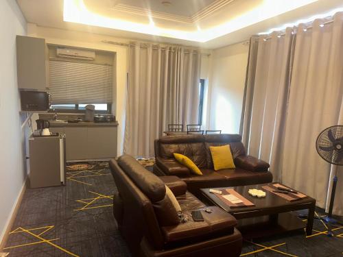 a living room with a couch and a table at Seven Heaven Plaza in Serekunda