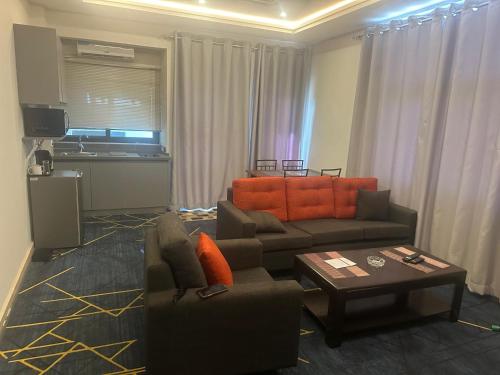 a living room with a couch and a table at Seven Heaven Plaza in Serekunda