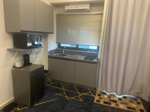 a small kitchen with a sink and a window at Seven Heaven Plaza in Serekunda