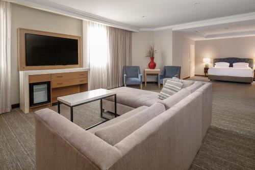 a living room with a couch and a flat screen tv at Hyatt Regency Valencia in Valencia