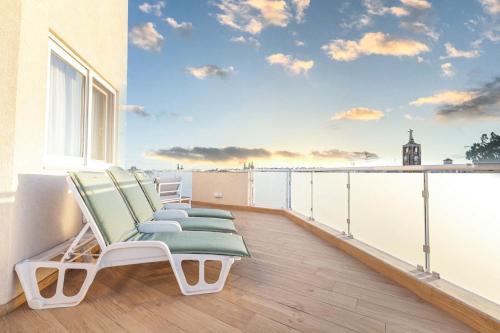 a row of lounge chairs on a balcony with a view at Luxurious & Spacious 2BD Penthouse with Large Terrace & Jacuzzi at The Podium - Yacht Marina Area, Close to Valletta in Msida